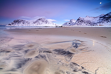 Full moon reflected on sand in the surreal scenery of Skagsanden beach, Flakstad, Nordland county, Lofoten Islands, Arctic, Norway, Scandinavia, Europe