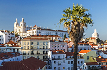 View of terracotta roofs and the ancient castle and dome from Miradouro Alfama viewpoint, Lisbon, Portugal, Europe