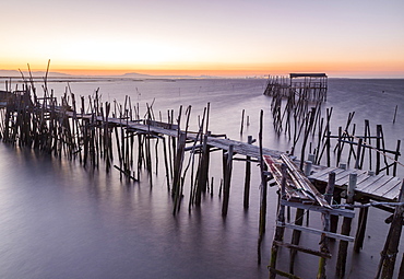 Sunset at Palafito Pier of Carrasqueira, Natural Reserve of Sado River, Alcacer do Sal, Setubal, Portugal, Europe