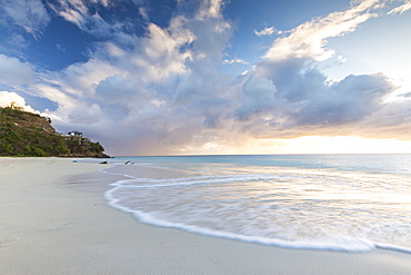 The sky turns pink at sunset and reflected on Ffryes Beach, Antigua, Antigua and Barbuda, Leeward Islands, West Indies, Caribbean, Central America