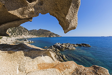 View of the blue sea from a natural sea cave of rocks shaped by wind, Punta Molentis, Villasimius, Cagliari, Sardinia, Italy, Mediterranean, Europe