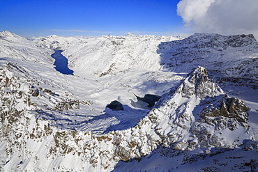 Aerial view of snowy Peak Peloso surrounded by Lago di Lei, Val di Lei Chiavenna, Spluga Valley, Valtellina, Lombardy, Italy, Europe