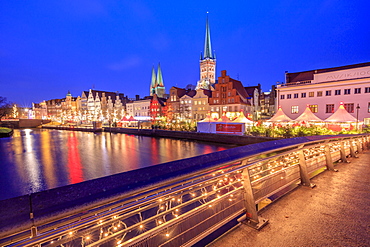 Night view of typical houses and the cathedral reflected in River Trave, Lubeck, Schleswig Holstein, Germany, Europe