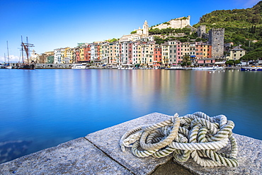 View from the pier of blue sea which frames the typical colored houses of Portovenere, UNESCO World Heritage Site, La Spezia Province, Liguria, Italy, Europe