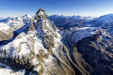 The massive shape of the Matterhorn sorrounded by its mountain range covered in snow, Swiss Canton of Valais, Swiss Alps, Switzerland, Europe