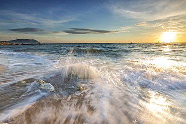 Waves crashing on the sandy beach framed by sunrise, Porto Recanati, Province of Macerata, Conero Riviera, Marche, Italy, Europe