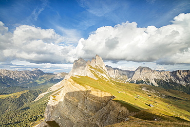 Blue sky and clouds on the rocky peaks of the Odle mountain range seen from Seceda, Val Gardena, Trentino-Alto Adige, Italy, Europe