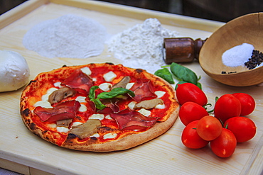 Set of typical Italian products of Bresaola of Valtellina, pizza with mushrooms, tomatoes from Sicily, mozzarella from Naples, Italy, Europe