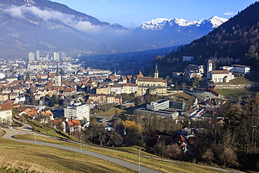 View of the city of Chur surrounded by woods and snowy peaks, district of Plessur, Canton of Graubunden, Swiss Alps, Switzerland, Europe