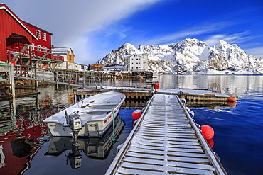 Jetty covered with snow after a night snowfall and boats docked in the harbor of Henningsvaer, Lofoten Islands, Arctic, Norway, Scandinavia, Europe