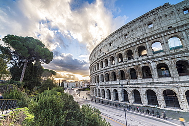 The pink sky at sunrise frames the ancient Colosseum (Flavian Amphitheatre), UNESCO World Heritage Site, Rome, Lazio, Italy, Europe