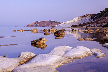 White cliffs known as Scala dei Turchi frame the calm sea at dawn, Porto Empedocle, Province of Agrigento, Sicily, Italy, Mediterranean, Europe