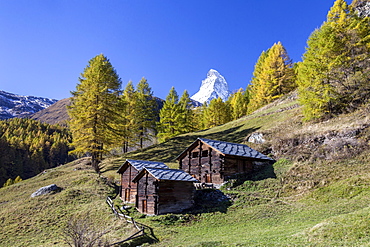 The unique shape of the Matterhorn seen from a little group of mountain huts by Zermatt, Swiss Canton of Valais, Swiss Alps, Switzerland, Europe