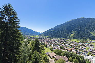 Blue sky and woods frame the alpine village of Pinzolo, Brenta Dolomites, Trentino-Alto Adige, Italy, Europe