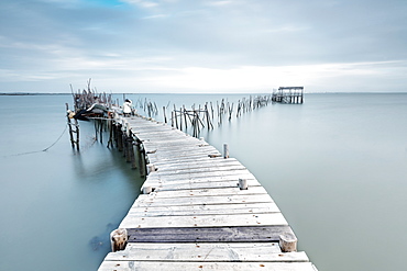 Soft light of dawn on the Palafito Pier, Carrasqueira Natural Reserve of Sado River, Alcacer do Sal, Setubal, Portugal, Europe