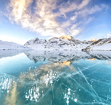 Panorama of ice bubbles and frozen surface of Lago Bianco at dawn, Bernina Pass, canton of Graubunden, Engadine, Switzerland, Europe