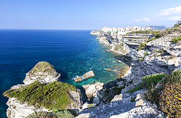 Turquoise sea frames the medieval old town and fortress perched on top of cliffs, Bonifacio, Corsica, France, Mediterranean, Europe