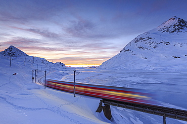 The Bernina Express red train, UNESCO World Heritage Site, Graubunden, Swiss Alps, Switzerland, Europe 