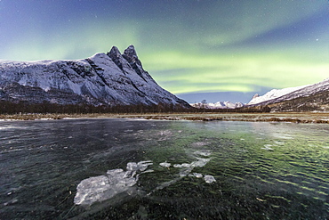 The snowy peak of Otertinden and the Northern Lights in the polar night, Oteren, Lyngen Alps, Troms, Norway, Scandinavia, Europe