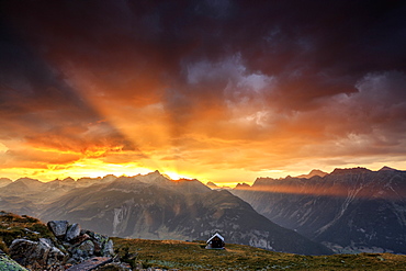 Rays of sun of fiery sky at sunset above the peaks, Muottas Muragl, St. Moritz, Canton of Graubunden, Engadine, Switzerland, Europe