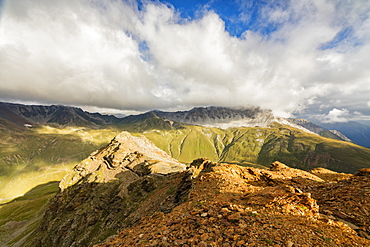 Sun and clouds on the rocky crest of the Alps, Filon del Mott, Bormio, Braulio Valley, Stelvio Pass, Valtellina, Lombardy, Italy, Europe