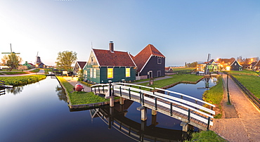 Panorama of wooden houses and windmills of the typical village of Zaanse Schans at dusk, North Holland, The Netherlands, Europe