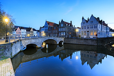 Dusk lights on the historic buildings of the city centre reflected in the typical canals, Bruges, West Flanders, Belgium, Europe