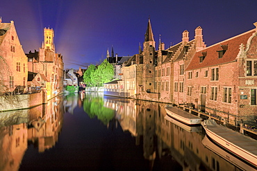 The medieval Belfry and historic buildings are reflected in Rozenhoedkaai canal at night, UNESCO World Heritage Site, Bruges, West Flanders, Belgium, Europe