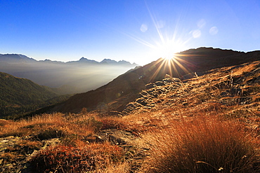 Sunbeams on alpine pastures with peak Scalino in the background, Val Torreggio, Malenco Valley, Valtellina, Lombardy, Italy, Europe