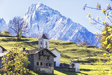 Alpine church framed by the snowy peak of Pizzo di Prata in spring, Daloo, Chiavenna Valley, Valtellina, Lombardy, Italy, Europe