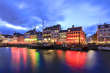 Night view of the illuminated harbour and canal of the entertainment district of Nyhavn, Copenhagen, Denmark, Europe