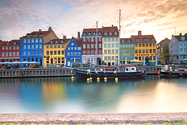 Sunrise on the colourful facades along the harbour in the district of Nyhavn, Copenhagen, Denmark, Europe