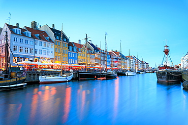 Night view of the illuminated harbour and canal of the entertainment district of Nyhavn, Copenhagen, Denmark, Europe