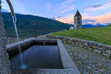 Stone fountain next to bell tower, Xenodochio of Santa Perpetua, Tirano, province of Sondrio, Valtellina, Lombardy, Italy, Europe