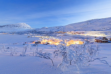 Illuminated village of Riksgransen at dusk, Abisko, Kiruna Municipality, Norrbotten County, Lapland, Sweden, Scandinavia, Europe