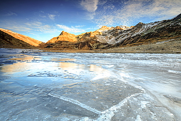 Frozen lake Montespluga at dawn, Chiavenna Valley, Sondrio province, Valtellina, Lombardy, Italy, Europe