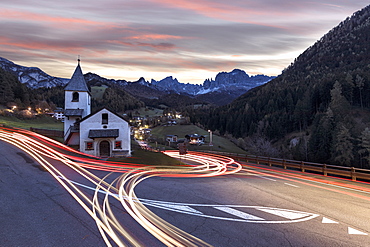 Lights of car trails around the Church of San Cipriano, Tires Valley, Dolomites, South Tyrol, Bolzano province, Italy, Europe