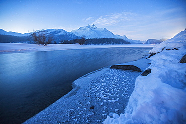 Piz Da La Margna and icy Lake Sils, Maloja, Engadine, Canton of Graubunden, Switzerland, Europe