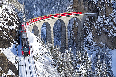 The red train of the Albula-Bernina Express Railway, UNESCO World Heritage on the Landwasser Viaduct, Switzerland, Europe