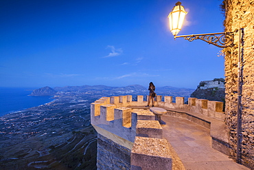 Woman on terrace looks towards Monte Cofano, Erice, province of Trapani, Sicily, Italy, Mediterranean, Europe