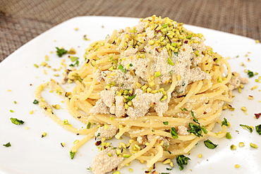 Pasta on platter with swordfish eggs garnished with Bronte pistachio, Sicily, Italy, Europe