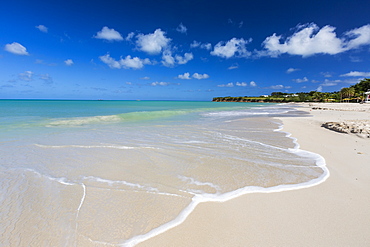 The waves of the Caribbean Sea crashing on the white sandy beach of Runaway Bay, north of the capital St. John's, Antigua, Leeward Islands, West Indies, Caribbean, Central America