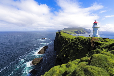 Lighthouse on islet known as Mykines Holmur, Mykines Island, Faroe Islands, Denmark, Europe