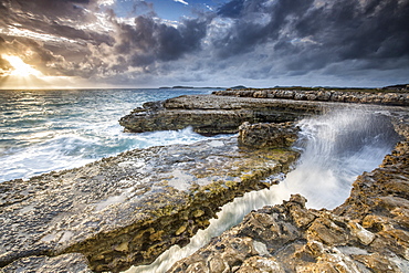 Rocks and crashing waves at Devil's Bridge, a natural arch carved by the sea, Antigua, Leeward Islands, West Indies, Caribbean, Central America