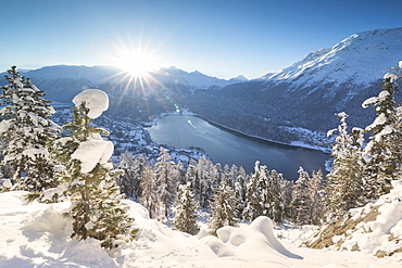 Sunrise over village and Lake of St. Moritz covered with snow, Engadine, Canton of Graubunden, Switzerland, Europe