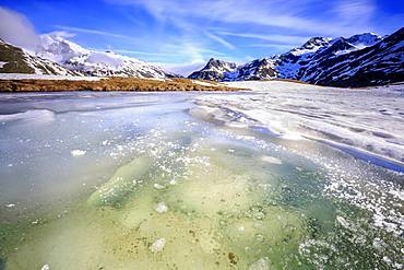 Ice melting at Lake Andossi during spring thaw, Chiavenna Valley, Spluga Valley, Sondrio province, Valtellina, Lombardy, Italy, Europe