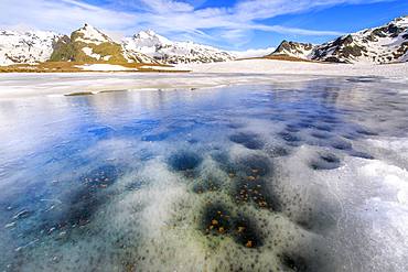 Ice melting at Lake Andossi during spring thaw, Chiavenna Valley, Spluga Valley, Sondrio province, Valtellina, Lombardy, Italy, Europe