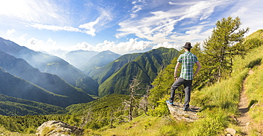 Panoramic of man on Monte Legnoncino with Valvarrone and Valsassina in the background, Lecco province, Lombardy, Italy, Europe