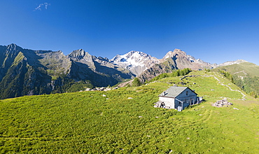 Panoramic aerial view of hut on green meadows, Scermendone Alp, Sondrio province, Valtellina, Rhaetian Alps, Lombardy, Italy, Europe