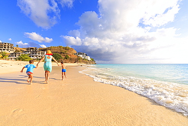 Woman and children running happily on Ffryes Beach, Antigua, Antigua and Barbuda, Leeward Islands, West Indies, Caribbean, Central America